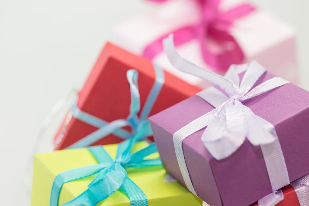 Selective-focus stack of colorful wrapped gift boxes with ribbons — gift guides for every occasion and personality, GiftyWow Guides