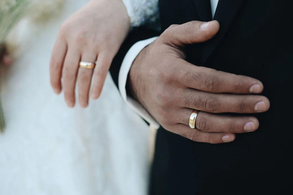 Close-up of bride and groom hands with wedding rings — wedding anniversary gift ideas hub (2026)