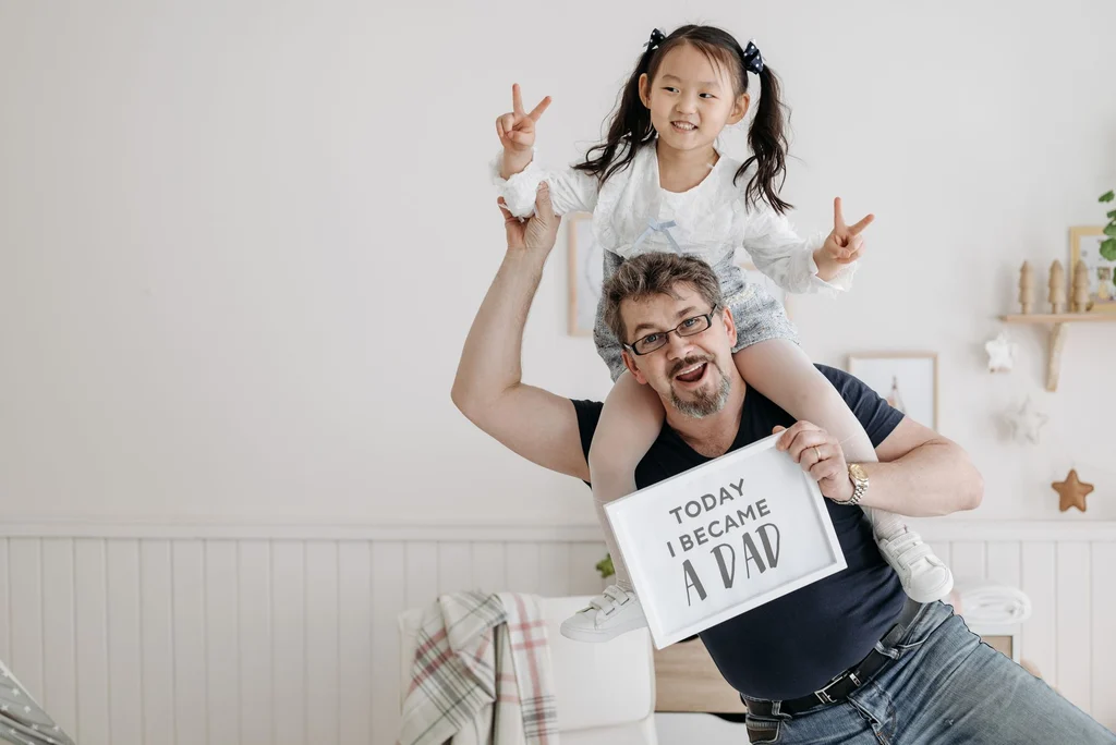 Father and daughter smiling together indoors, Father's Day gift ideas hub (2026)